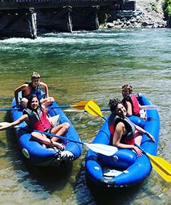 two couples relaxing in kayaks